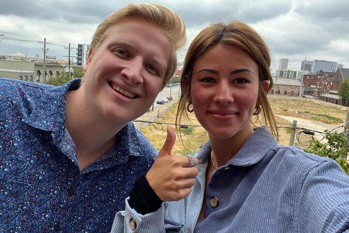 a man and a woman giving a thumbs up