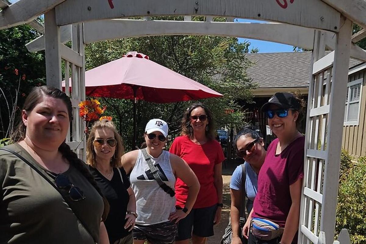 a group of people standing under a pergola