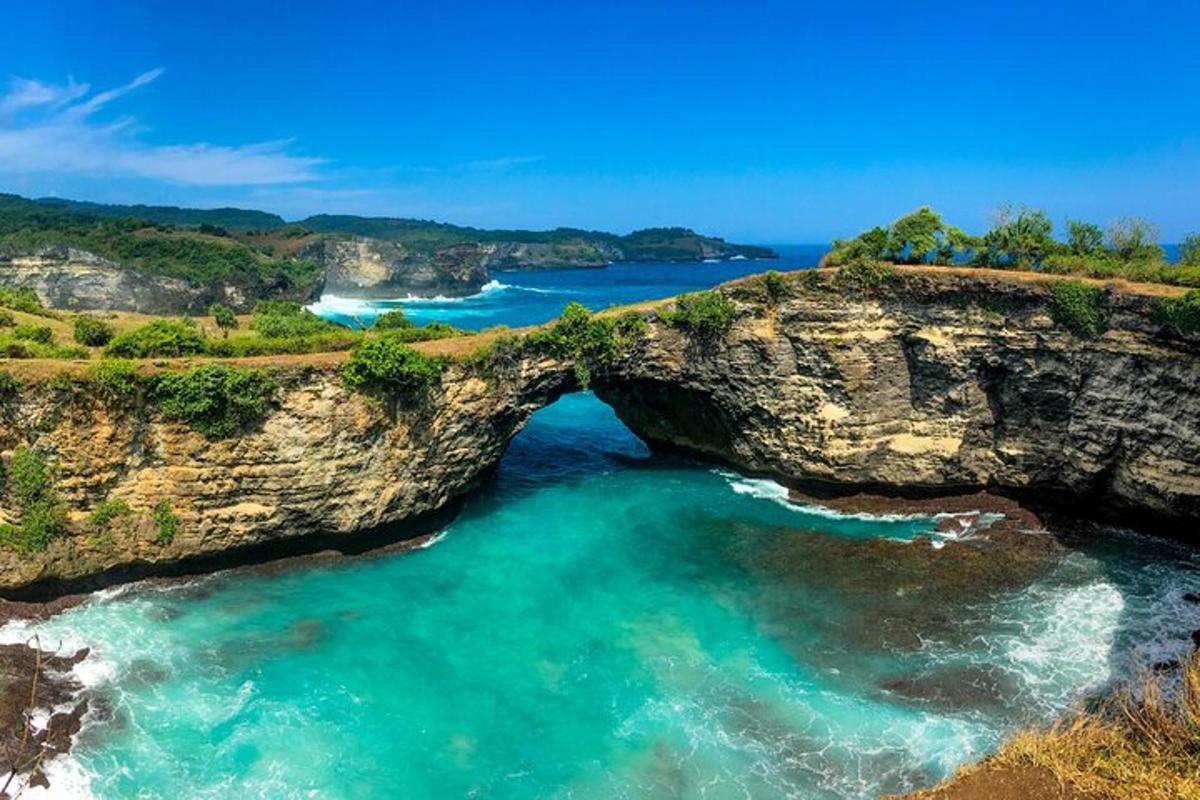 an island with an arch in the ocean