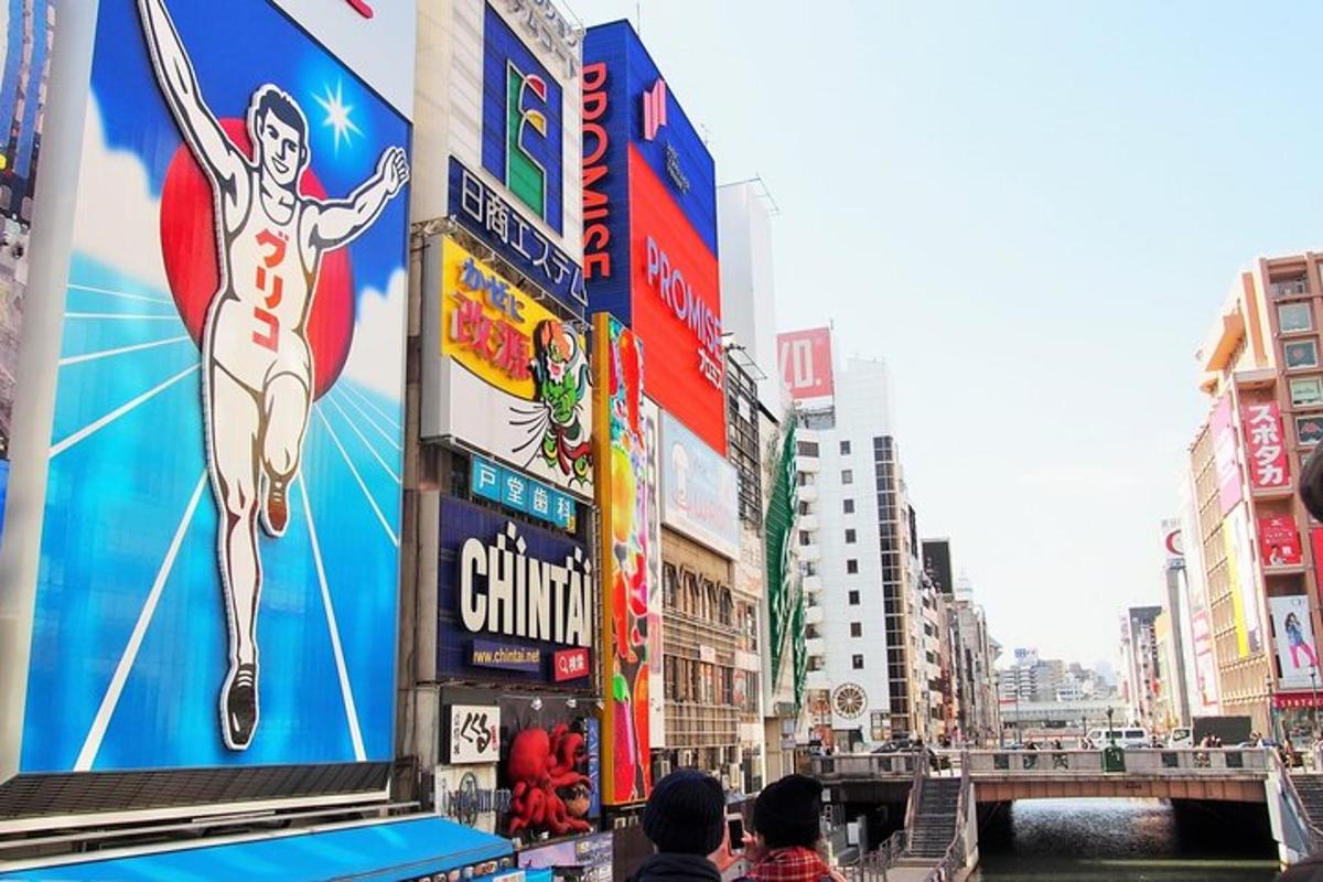 a group of people standing in a city with billboards