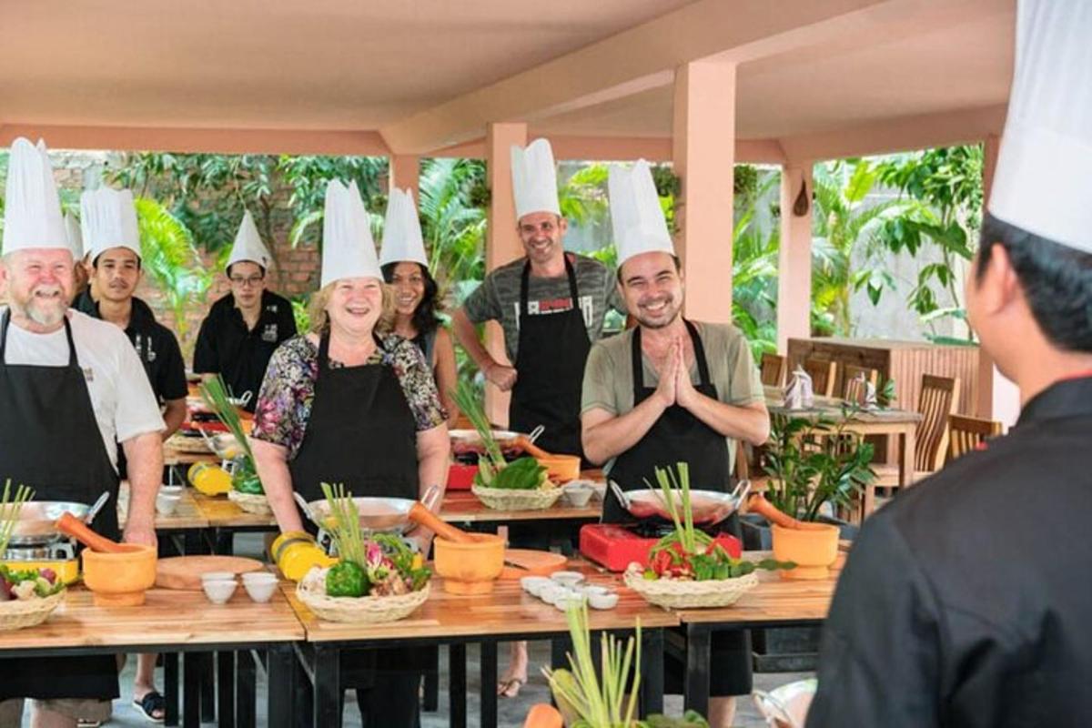 a group of people wearing chefs hats in a kitchen