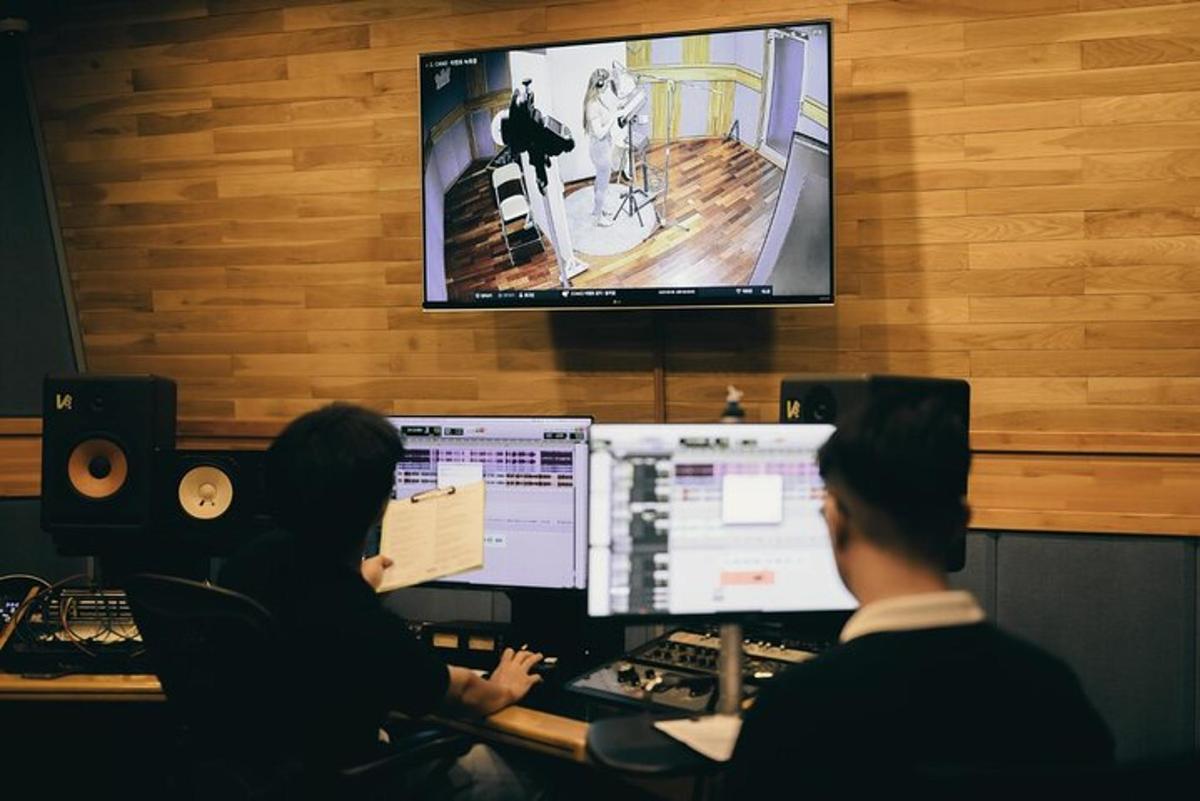 two people sitting at a desk with a computer