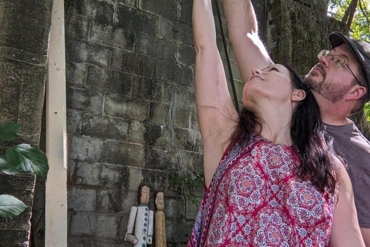 a man and a woman with their arms in the air