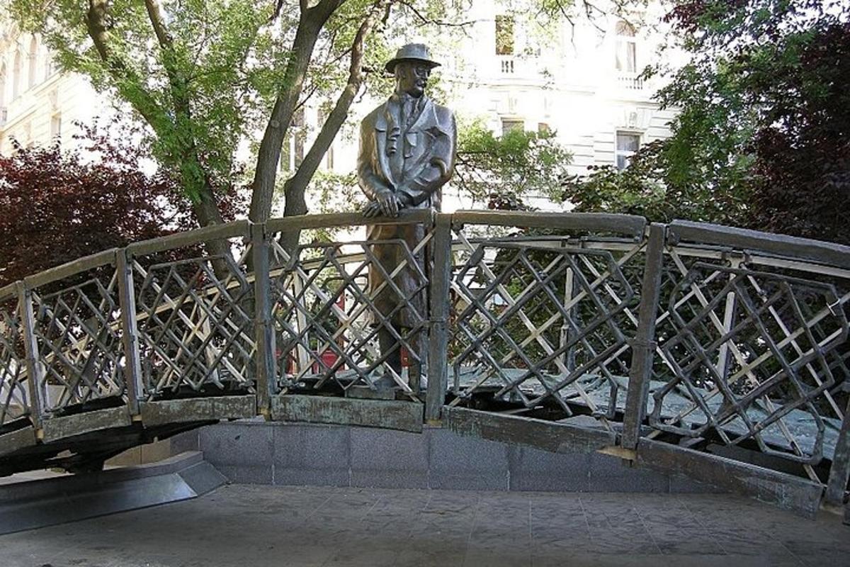 a statue of a man standing on a bridge