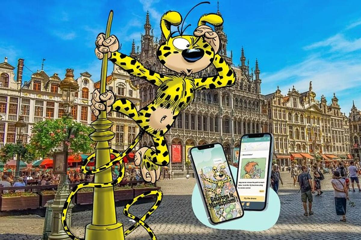 a statue of a mickey mouse holding a cell phone