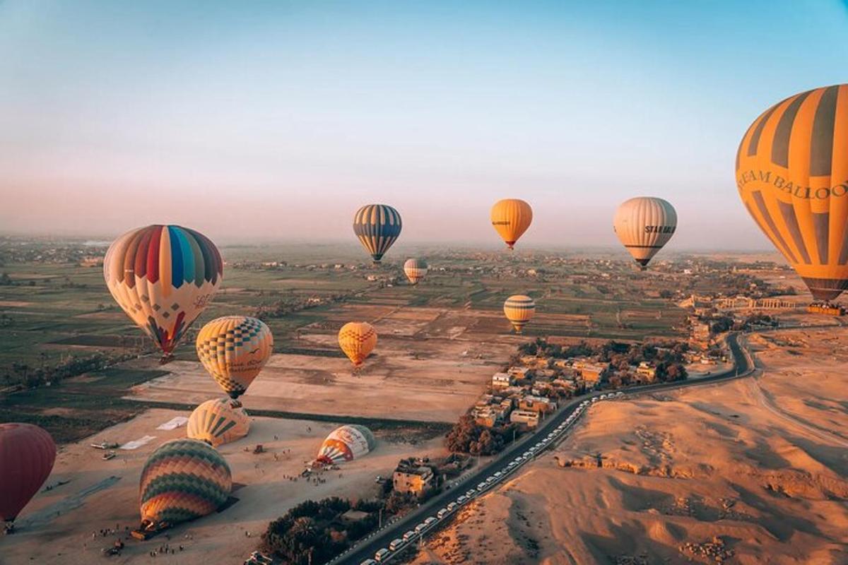 a group of hot air balloons flying over a city