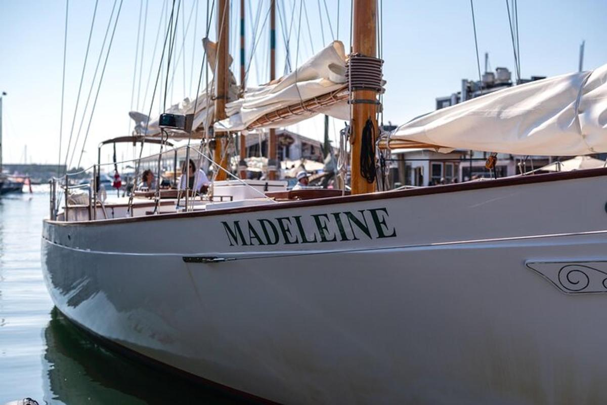 a white boat is docked in the water