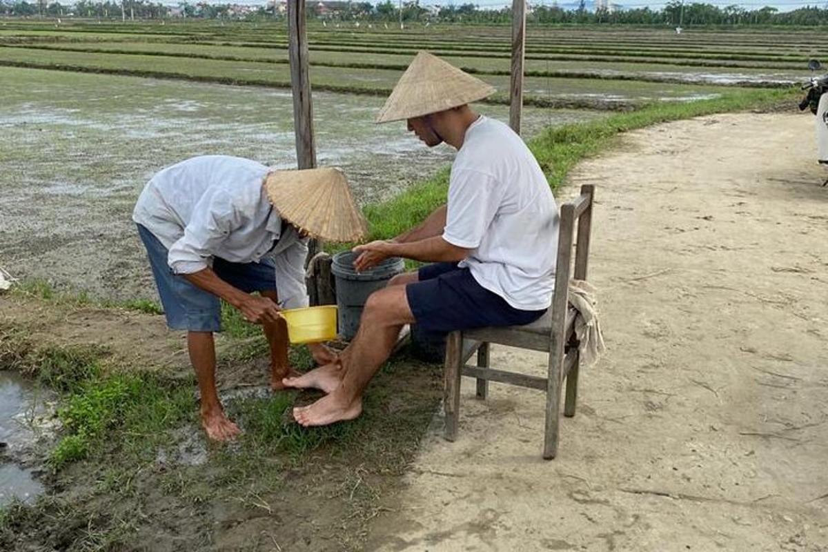 two men in straw hats are sitting on a chair