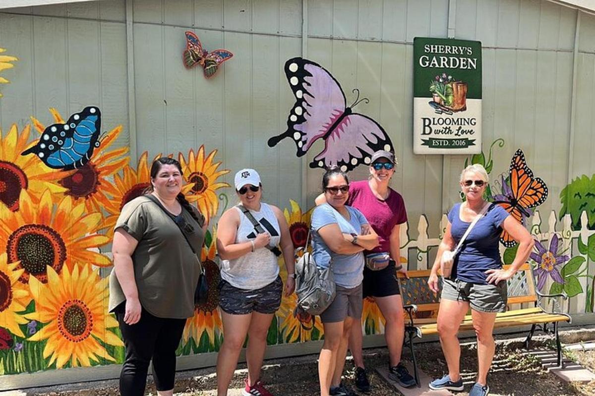 a group of women standing in front of a building with butterflies