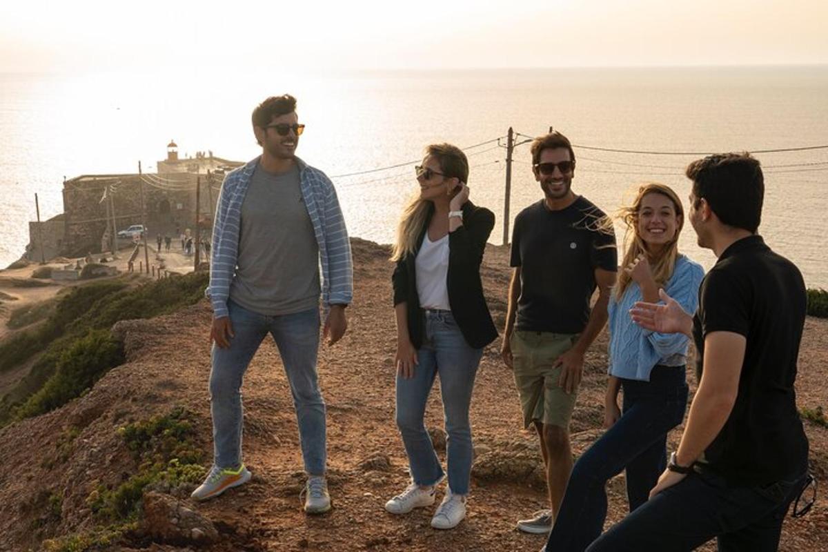 um grupo de pessoas em pé no topo de um penhasco
