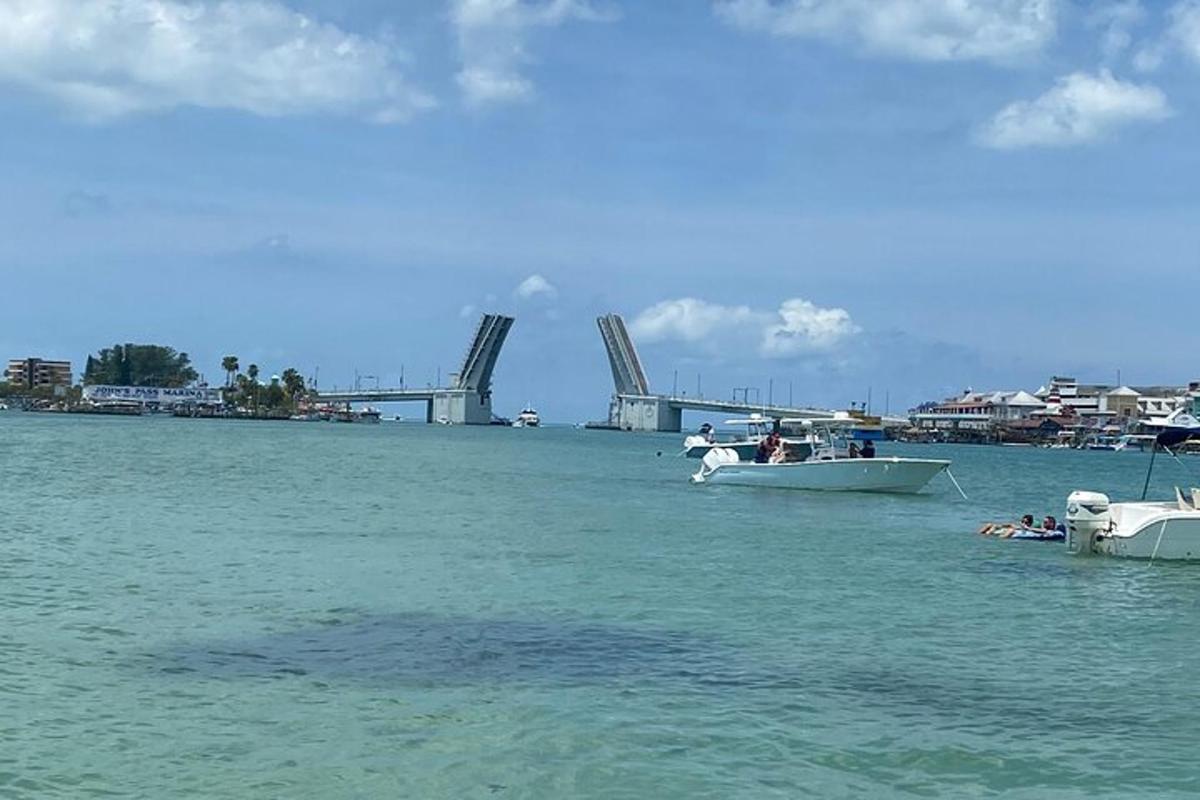 two boats in the water with a bridge in the background