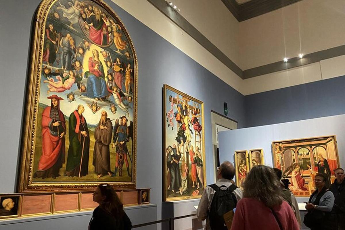 a group of people looking at paintings in a museum