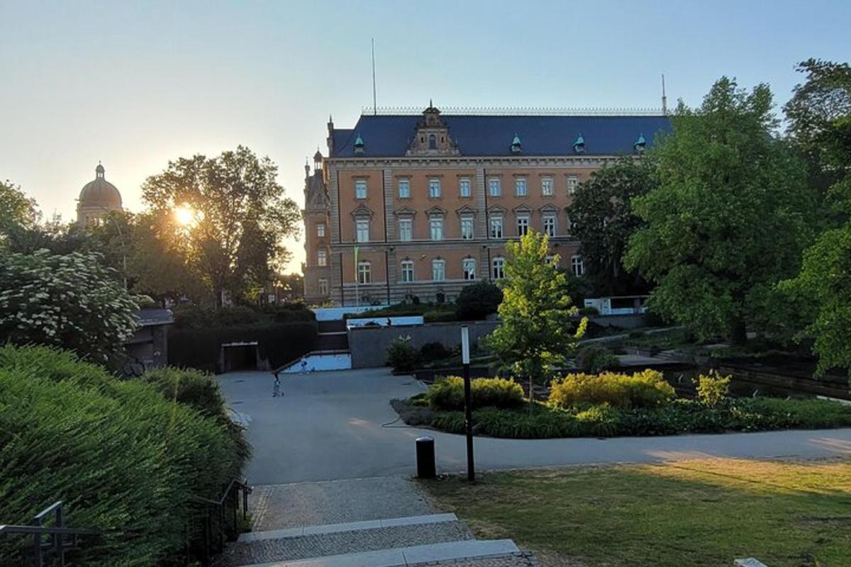 velika opečnata stavba s sončnim zahodom v ozadju