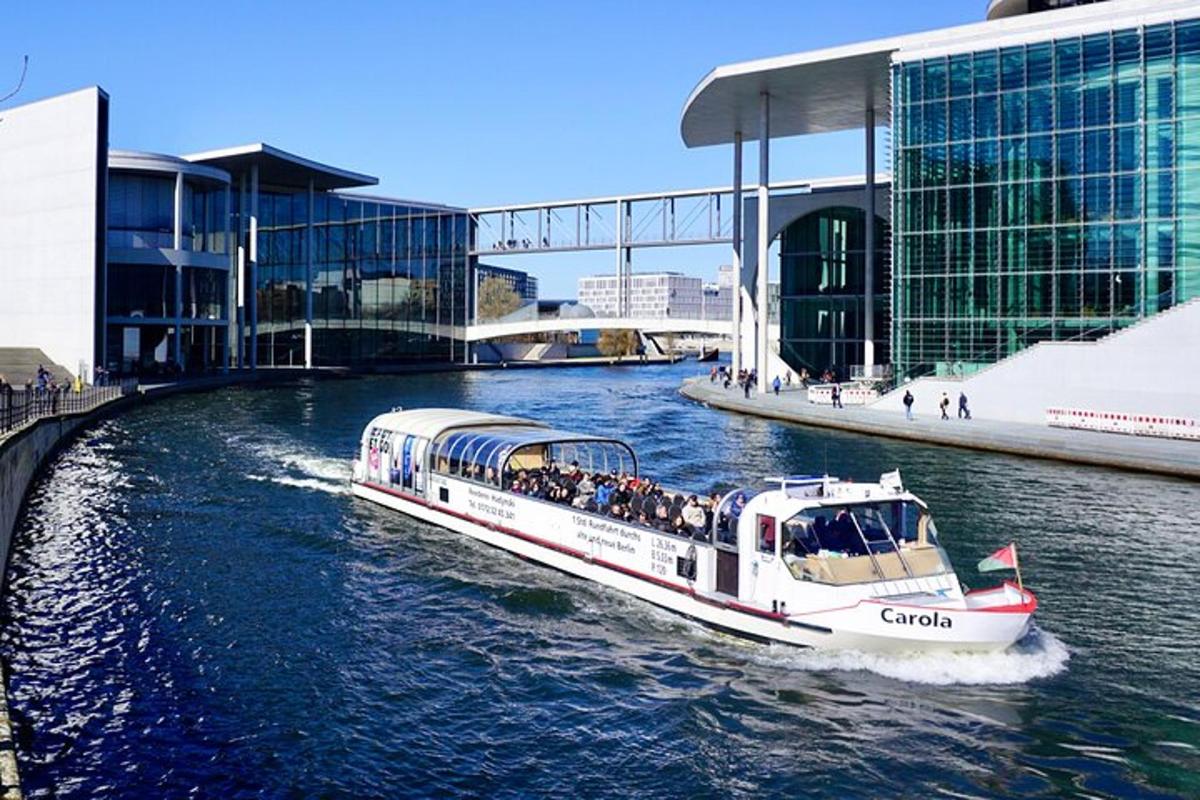 a boat traveling down a river in front of a building