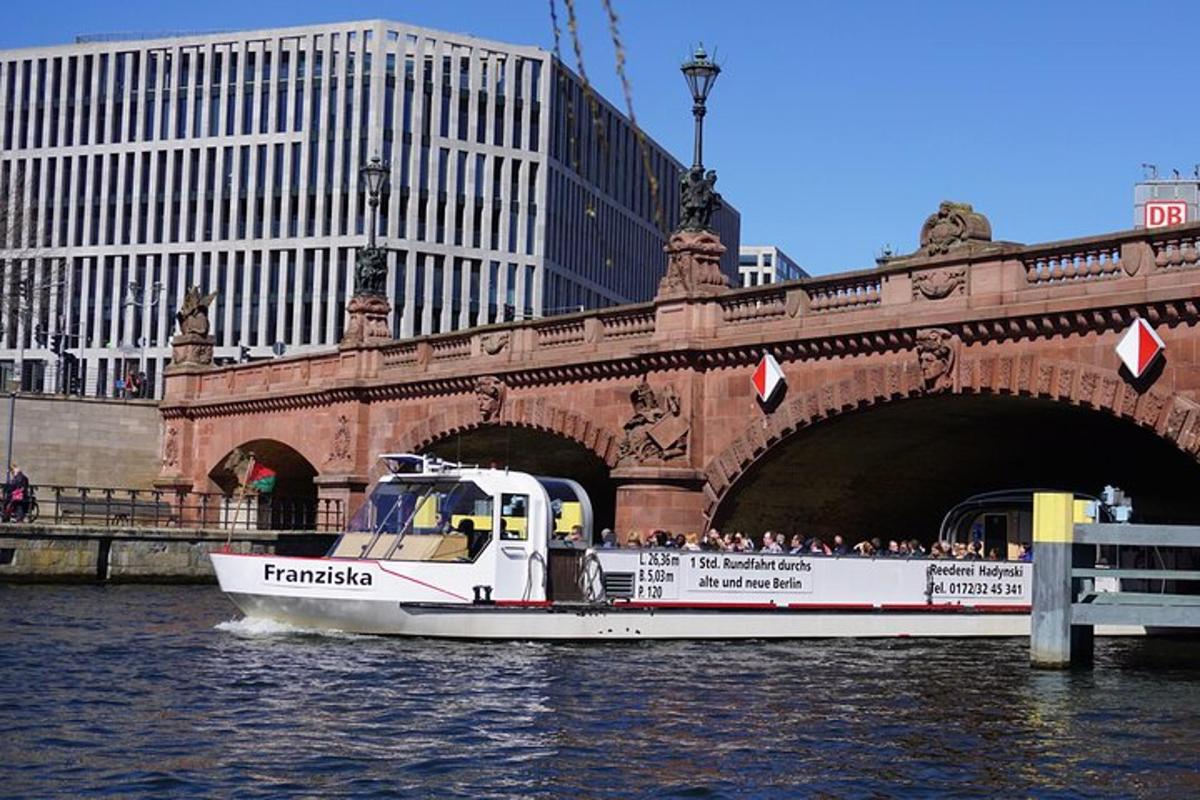 a boat in the water in front of a bridge