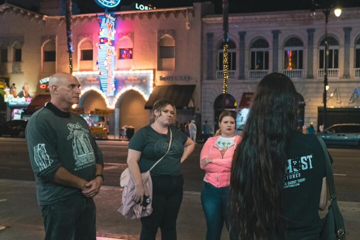 a group of people standing on a street at night