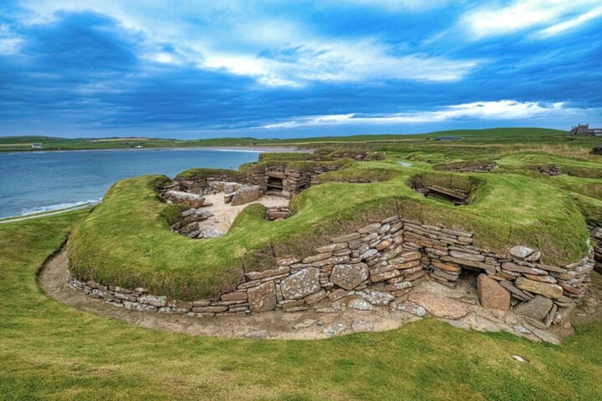 an old stone building next to a body of water