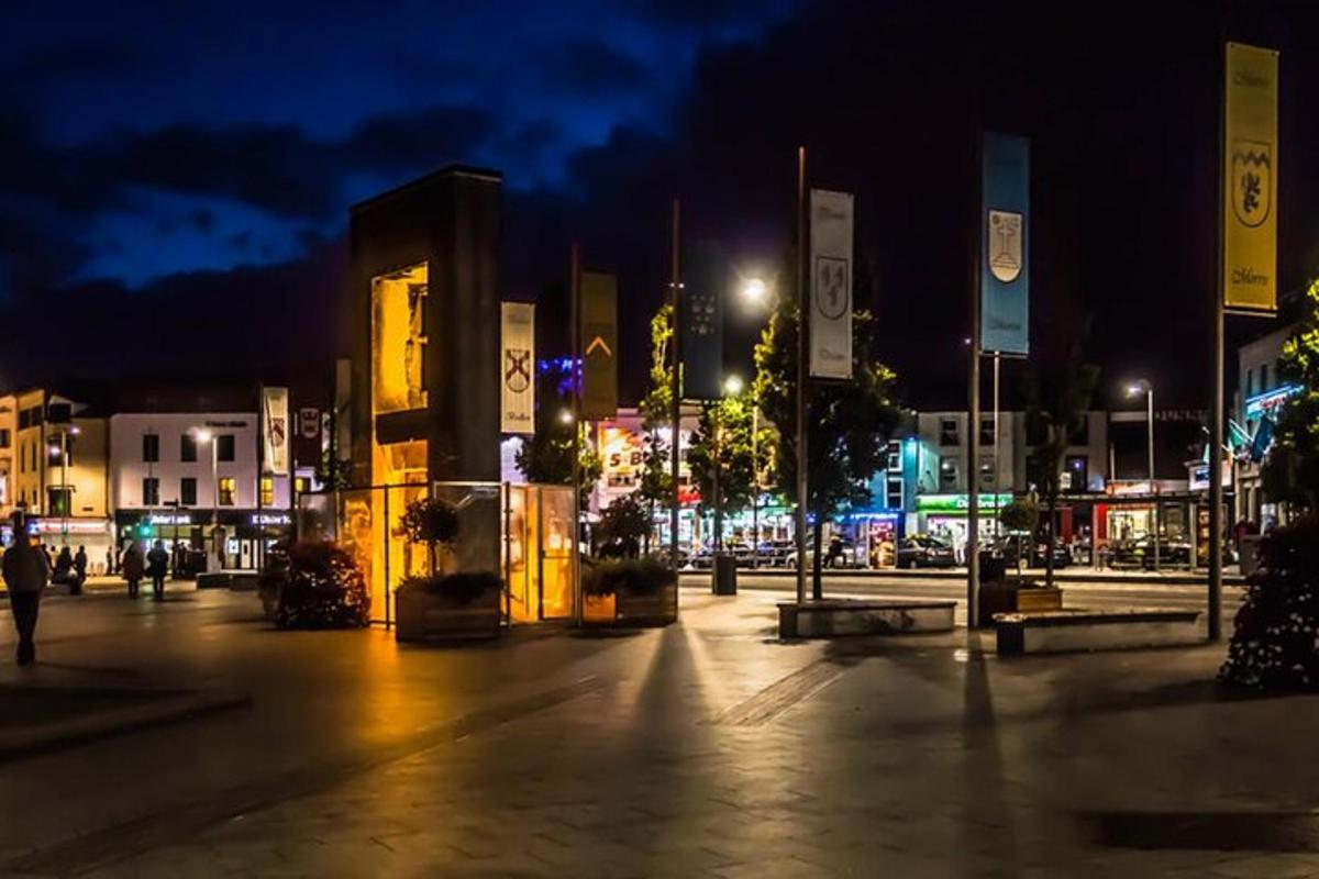 a city street at night with buildings and lights