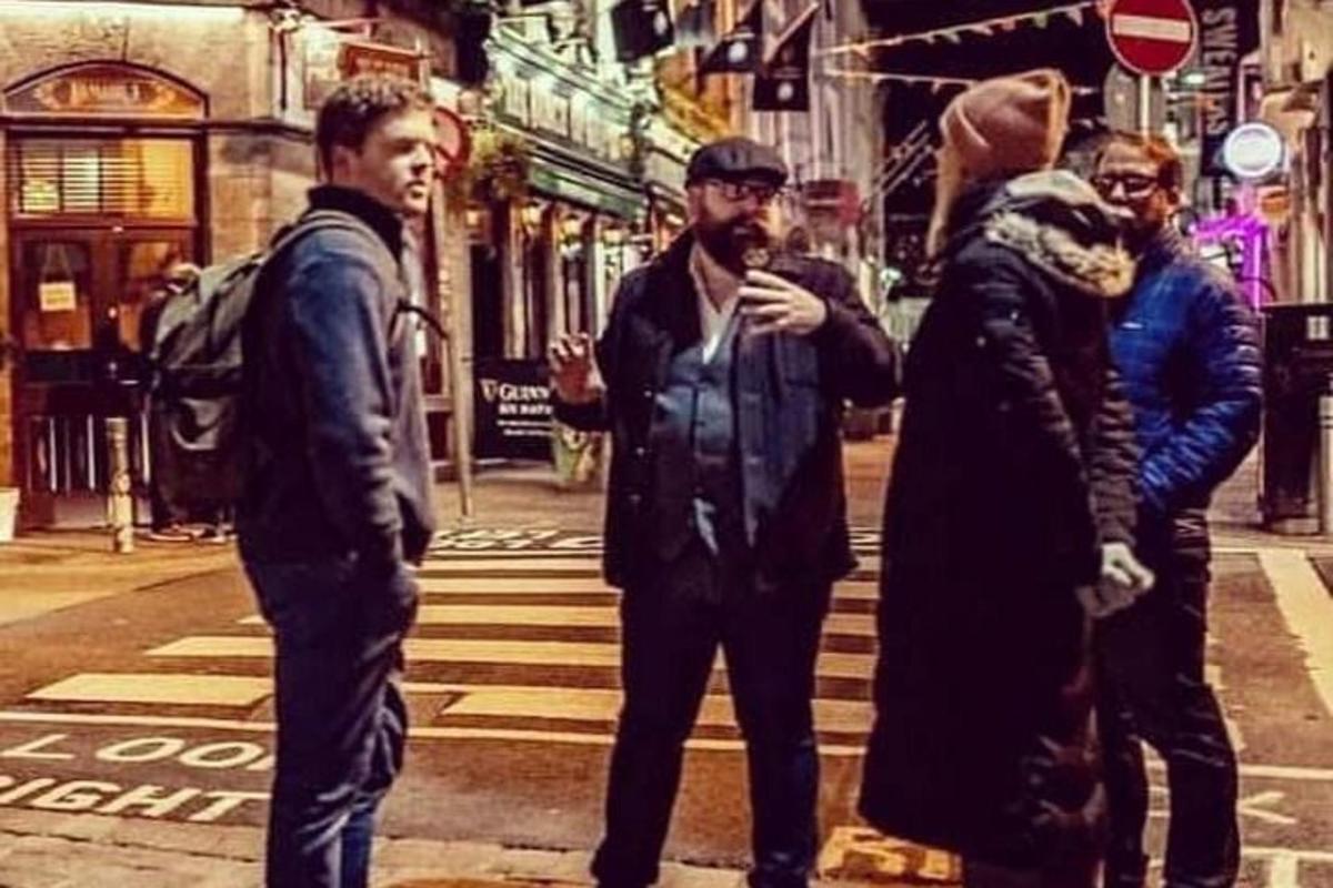 a group of men standing on a city street