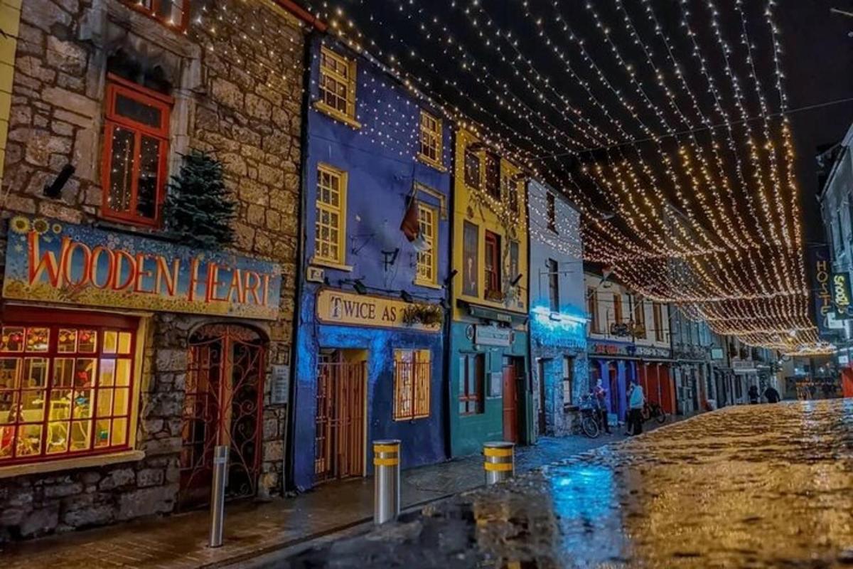 an empty street with christmas lights on a building