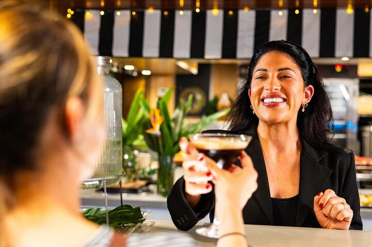 a woman sitting at a table holding a glass of wine