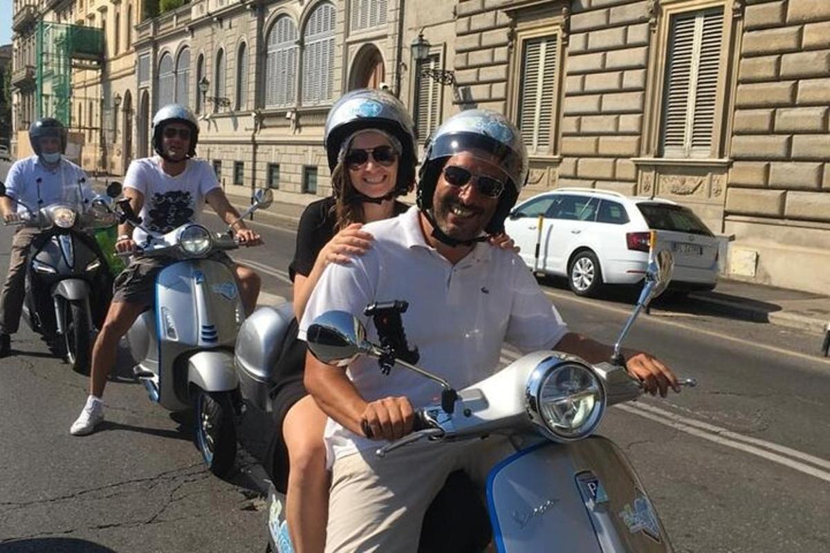 a group of people riding on scooters down the street