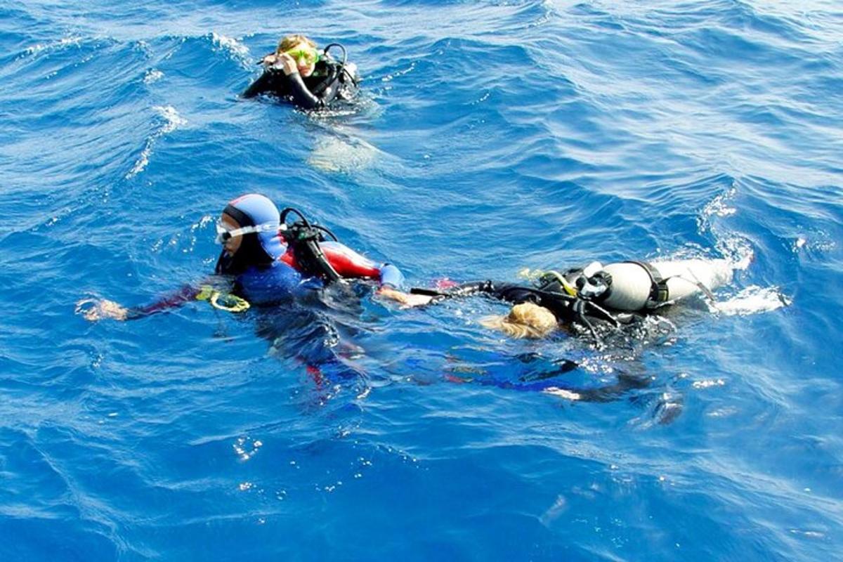 three people in the water in the ocean