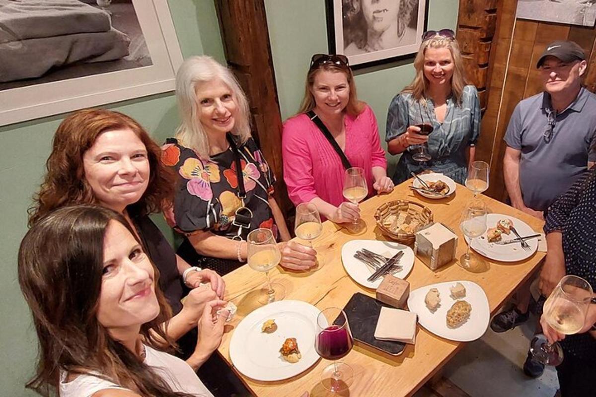 a group of women sitting around a table with wine glasses