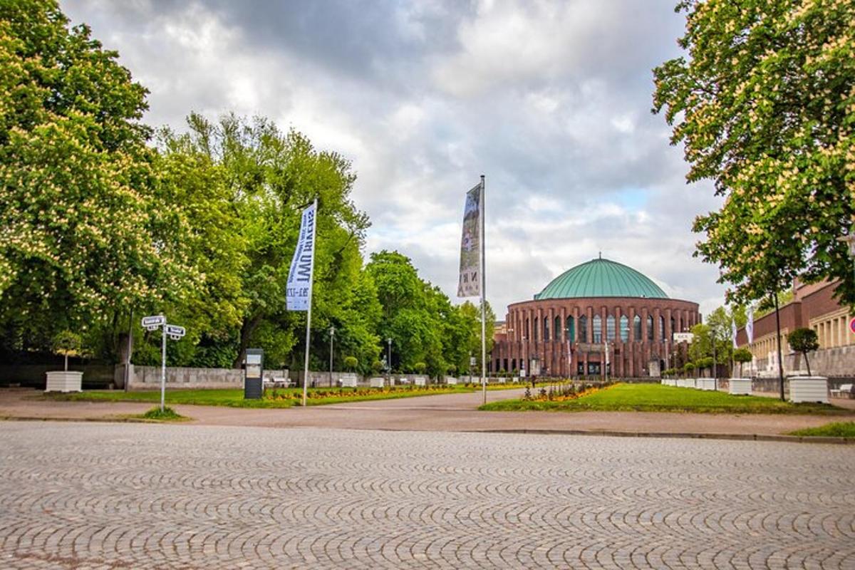 a large building with a green dome and a building