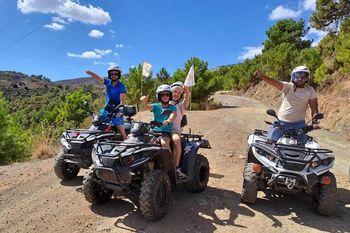 a group of people on atvs on a dirt road
