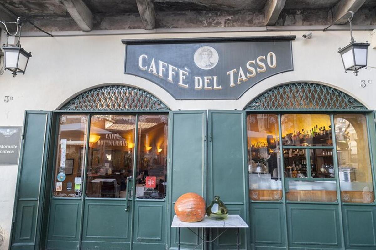 a cafe del taza with a pumpkin in front of it