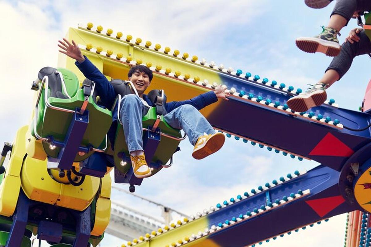 a man riding on a roller coaster at a theme park