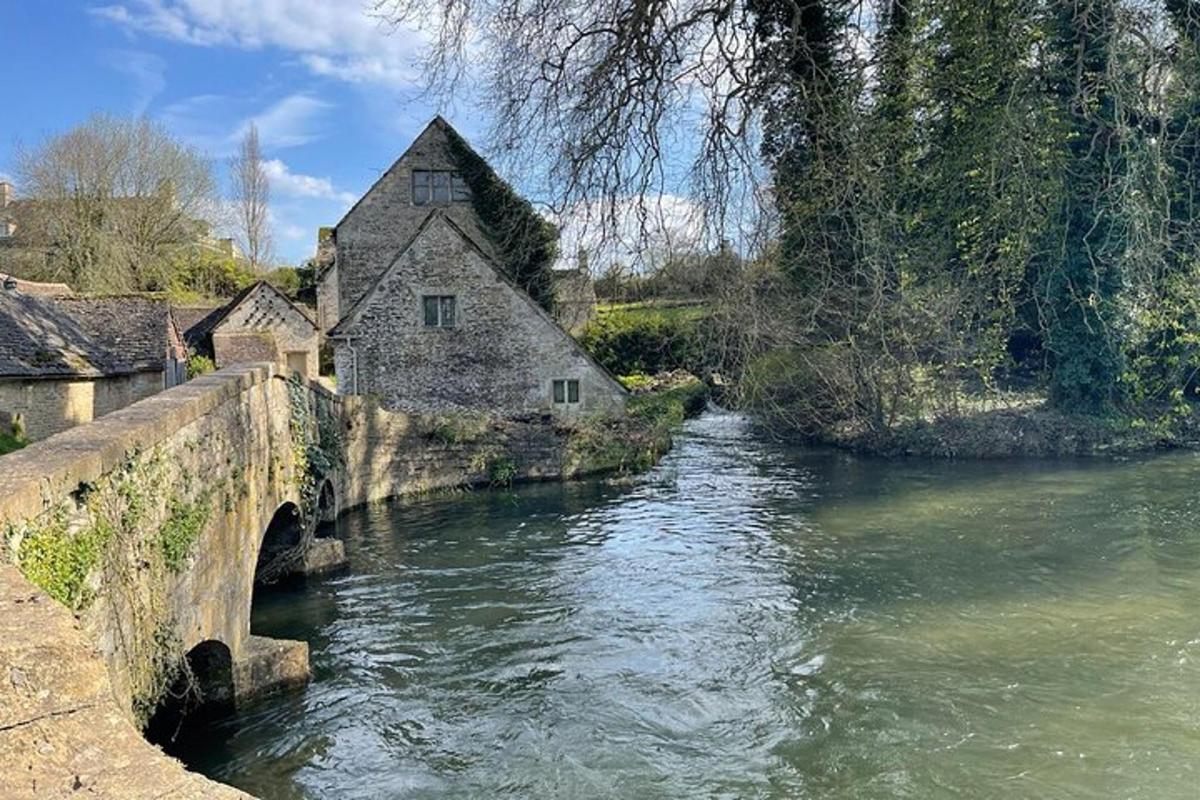 an old house on a bridge over a river