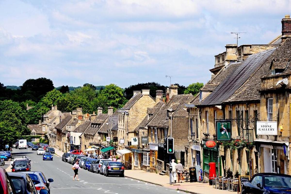 a town with cars parked on a street with buildings