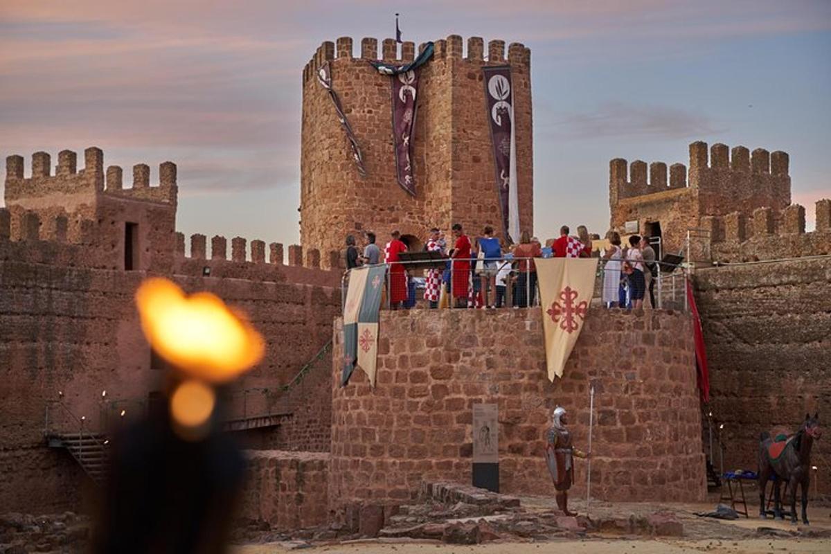 a group of people standing on top of a castle