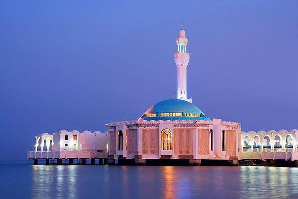 a mosque with a tower on top of the water