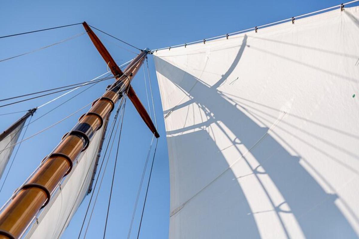a large white sail on a tall ship