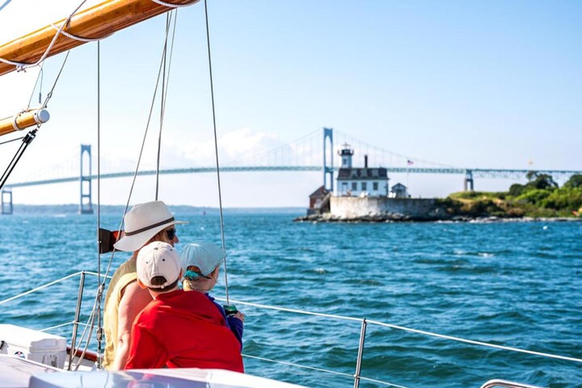 a man and woman on a boat with a bridge in the background