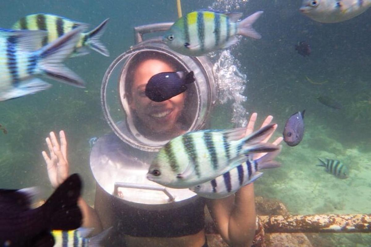 a person in a mirror with fish in the water