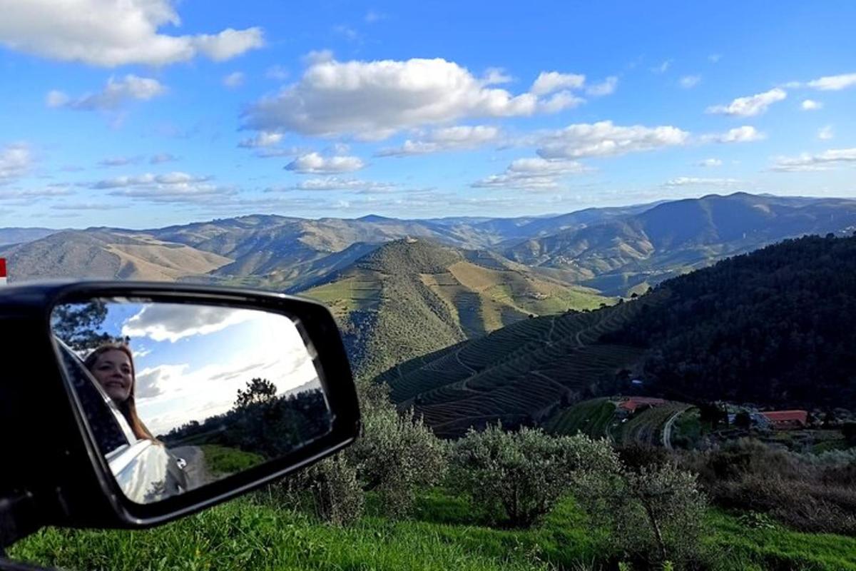a woman in the side view mirror of a car