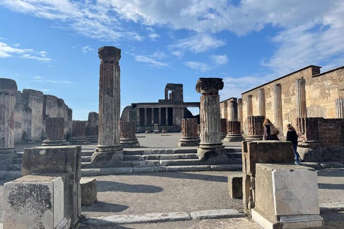 a person standing in front of a building with columns