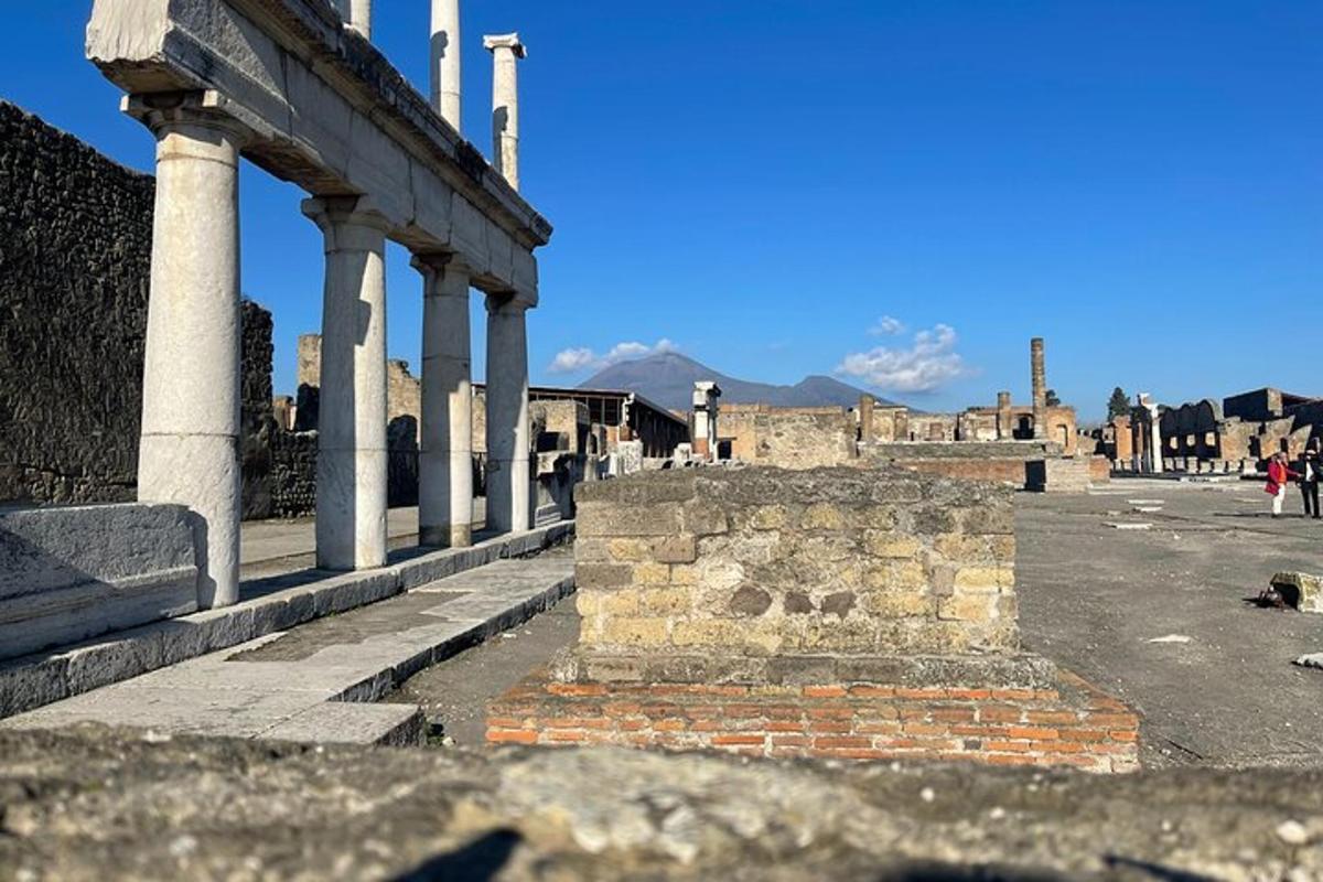 ancient ruins of a building with columns on a street