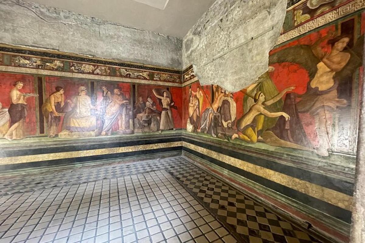a room with paintings on the walls of a building