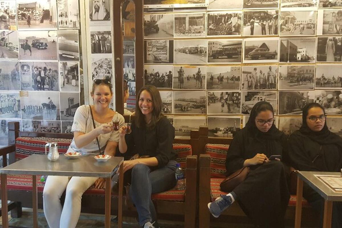 a group of people sitting on a bench in a restaurant