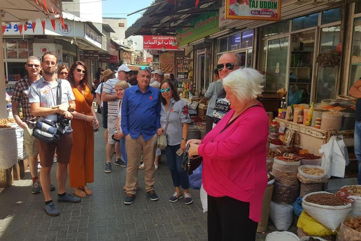 a group of people standing outside of a market