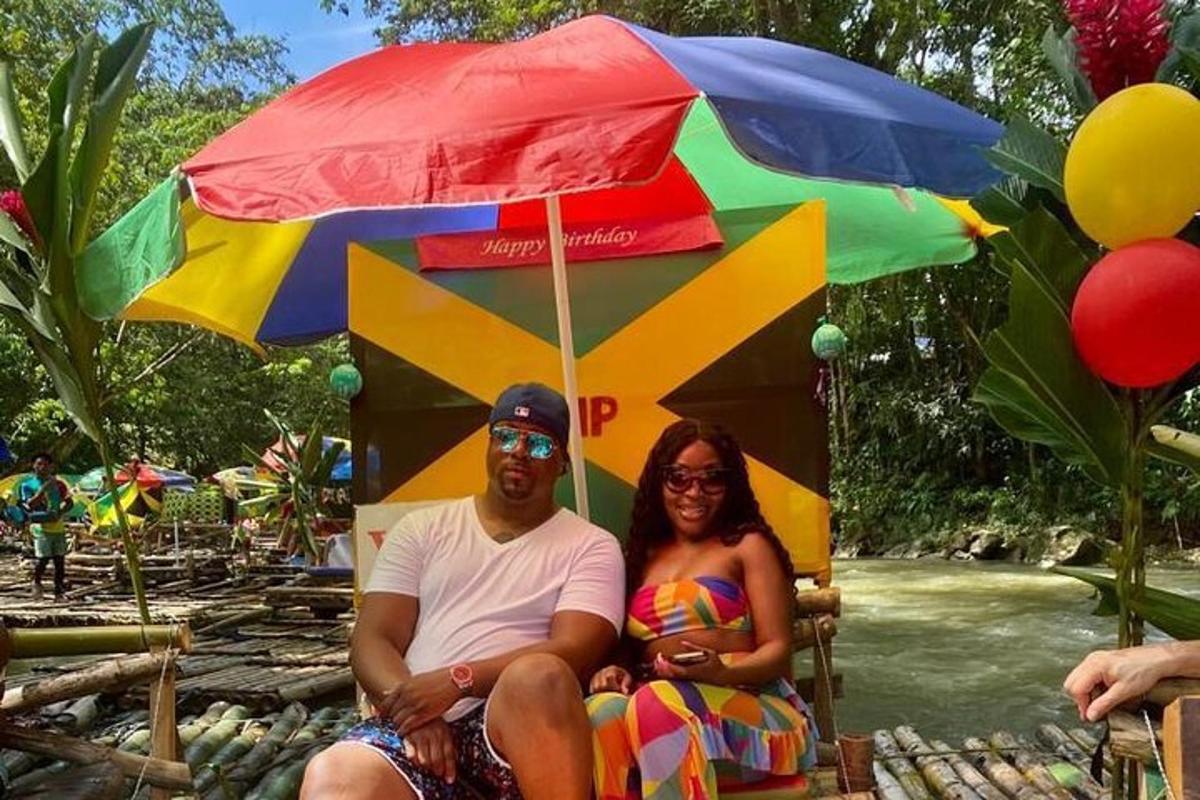 a man and a woman sitting under an umbrella