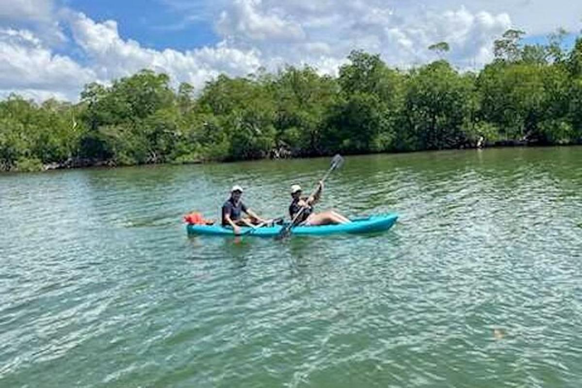two people are in a kayak on a river