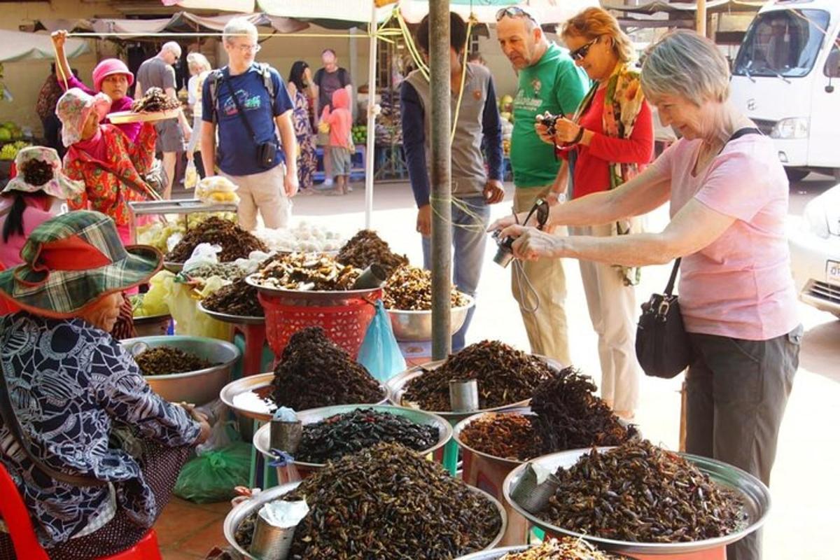 a group of people standing around a display of insects