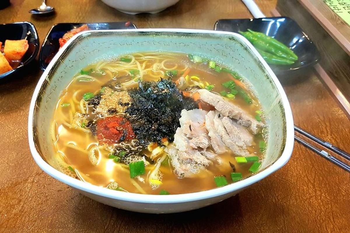 a bowl of chicken noodle soup on a table