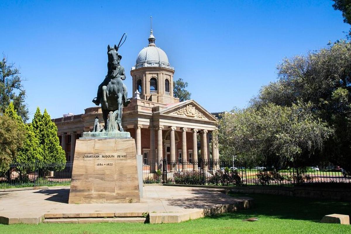 a statue in front of a building with a statue